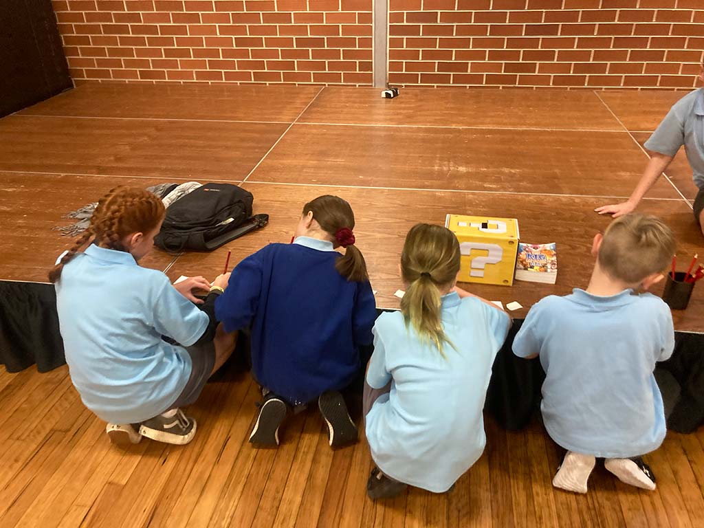 SRE students writing questions to submit into a mario-themed question box